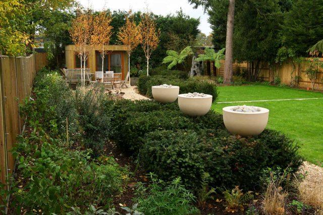 Epsom, Surrey landscaped garden lawn, minimalist design with pebble border and Birch trees, Ewell, Surrey contractor specialists, lawns, pathways, driveways.