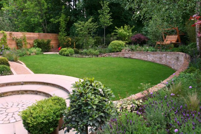 Family Garden in Hill Muswell providing space and tranquillity, modern slatted trellis, hard landscaping, slate terrace