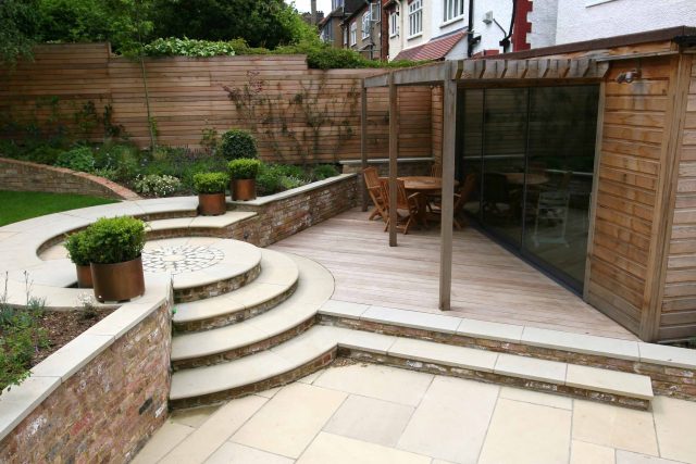 Family Garden in Hill Muswell providing space and tranquillity, modern slatted trellis, hard landscaping, slate terrace
