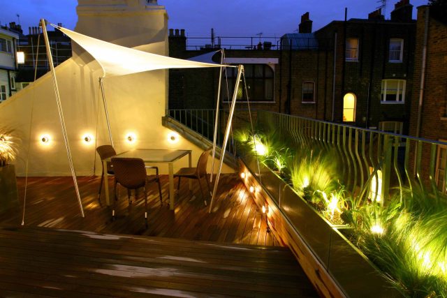 City Roof Terrace Marylebone W1 designed by Joan Edlis of Joan Edlis Associates and built by the Garden Builders decked floor surface, stainless steel planters.