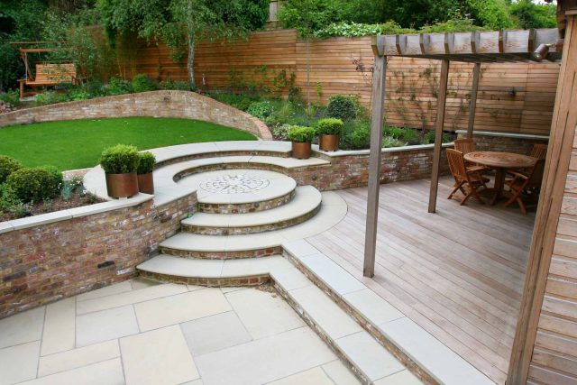 Family Garden in Hill Muswell providing space and tranquillity, modern slatted trellis, hard landscaping, slate terrace
