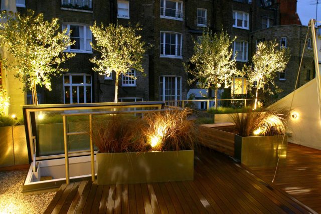City Roof Terrace Marylebone W1 designed by Joan Edlis of Joan Edlis Associates and built by the Garden Builders decked floor surface, stainless steel planters.