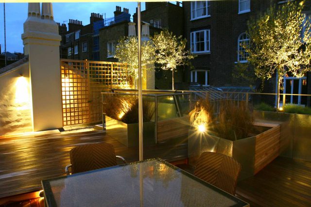 City Roof Terrace Marylebone W1 designed by Joan Edlis of Joan Edlis Associates and built by the Garden Builders decked floor surface, stainless steel planters.