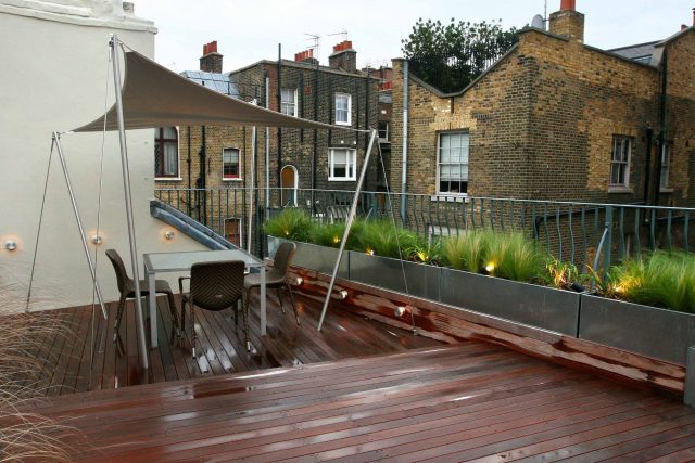 City Roof Terrace Marylebone W1 designed by Joan Edlis of Joan Edlis Associates and built by the Garden Builders decked floor surface, stainless steel planters.