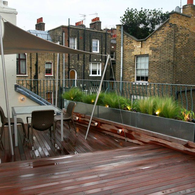 City Roof Terrace Marylebone W1 designed by Joan Edlis of Joan Edlis Associates and built by the Garden Builders decked floor surface, stainless steel planters.