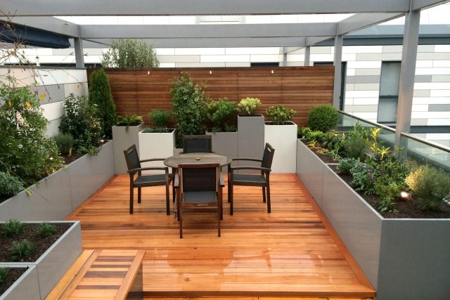 Kings Cross Roof Terrace at new apartments, Pippa Martlew, Cedar timber, aluminium planters, looks fantastic at night challenging build specialist company.