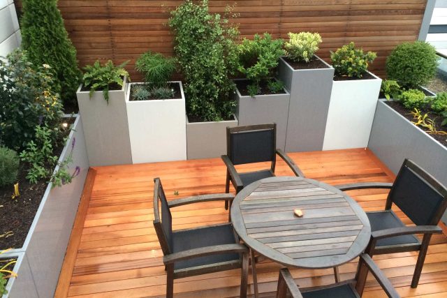 Kings Cross Roof Terrace at new apartments, Pippa Martlew, Cedar timber, aluminium planters, looks fantastic at night challenging build specialist company.