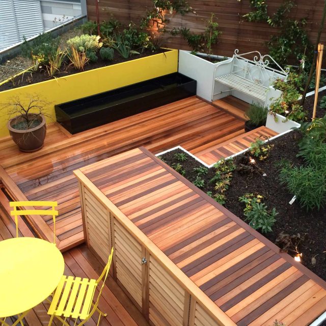 Kings Cross Roof Terrace at new apartments, Pippa Martlew, Cedar timber, aluminium planters, looks fantastic at night challenging build specialist company.