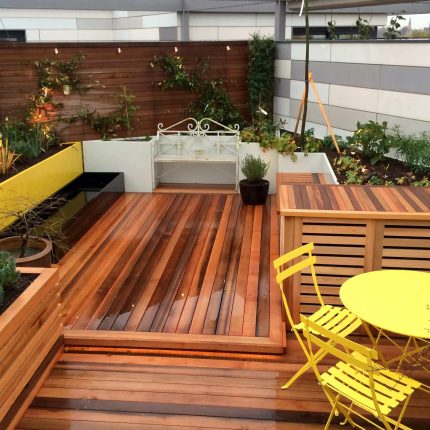 Kings Cross Roof Terrace at new apartments, Pippa Martlew, Cedar timber, aluminium planters, looks fantastic at night challenging build specialist company.
