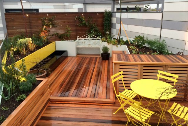 Kings Cross Roof Terrace at new apartments, Pippa Martlew, Cedar timber, aluminium planters, looks fantastic at night challenging build specialist company.