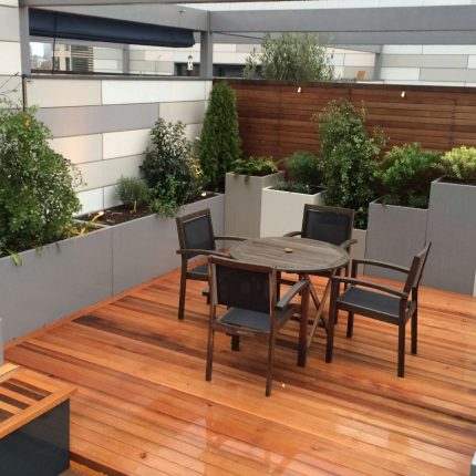 Kings Cross Roof Terrace at new apartments, Pippa Martlew, Cedar timber, aluminium planters, looks fantastic at night challenging build specialist company.