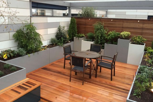 Kings Cross Roof Terrace at new apartments, Pippa Martlew, Cedar timber, aluminium planters, looks fantastic at night challenging build specialist company.