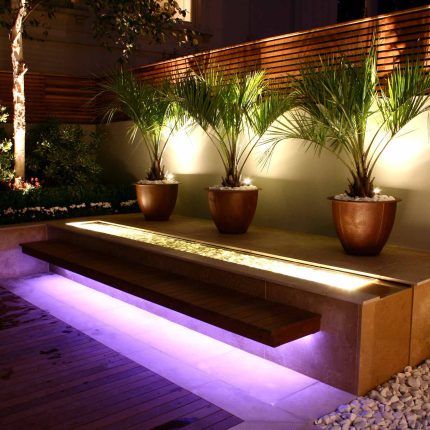 Contemporary outdoor garden space designed by Kate Gould and built by the Garden Builders, water feature, floating bench, cedar bench, landscaping contractors.