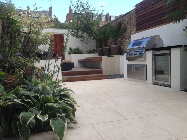 Contemporary Chelsea town garden with stainless steel BBQ unit, fridge and storage cupboard a zone for relaxing and entertaining, specialist company London.