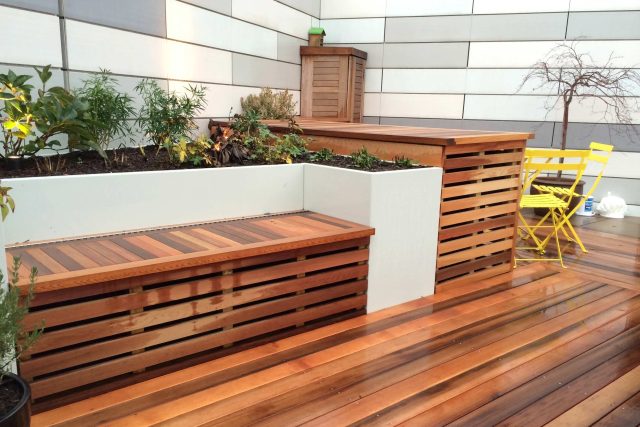 Kings Cross Roof Terrace at new apartments, Pippa Martlew, Cedar timber, aluminium planters, looks fantastic at night challenging build specialist company.