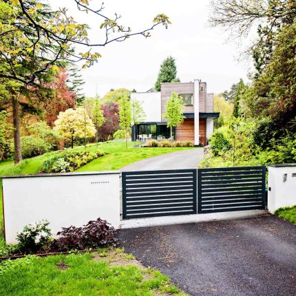 Farnham Garden Design Purbeck stone with multi-level Ipe hardwood decking, lawns and wild flower meadow and sculptural fire table Surrey landscaping.