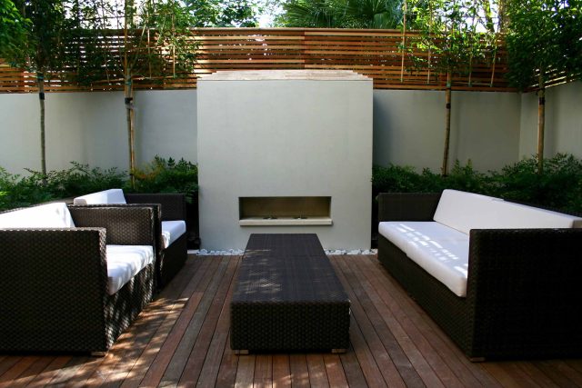 Contemporary outdoor garden space designed by Kate Gould and built by the Garden Builders, water feature, floating bench, cedar bench, landscaping contractors.