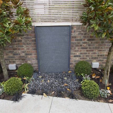 Contemporary yet elegant garden design in Notting Hill, with good entertaining space, slate water feature and sculpture, beautiful communal garden landscaper.