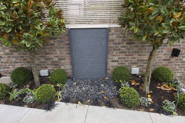 Contemporary yet elegant garden design in Notting Hill, with good entertaining space, slate water feature and sculpture, beautiful communal garden landscaper.