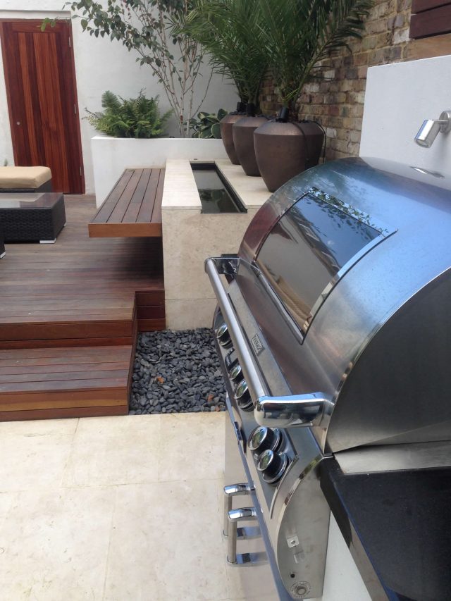 Contemporary Chelsea town garden with stainless steel BBQ unit, fridge and storage cupboard a zone for relaxing and entertaining, specialist company London.