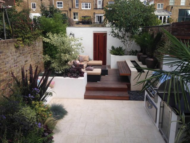 Contemporary Chelsea town garden with stainless steel BBQ unit, fridge and storage cupboard a zone for relaxing and entertaining, specialist company London.
