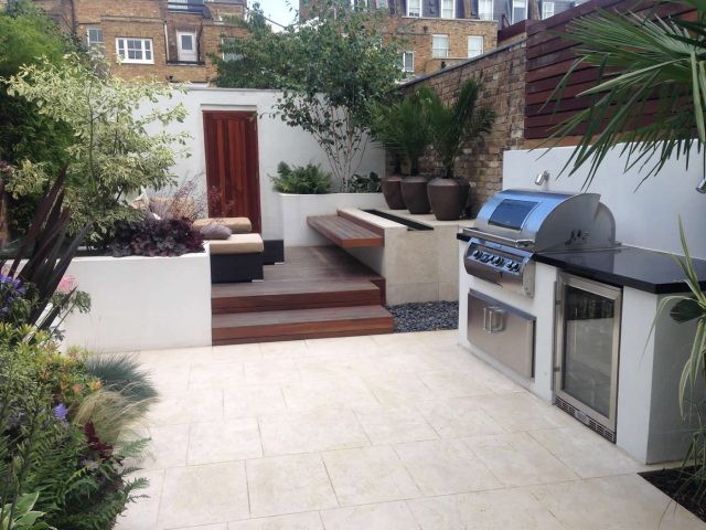 Contemporary Chelsea town garden with stainless steel BBQ unit, fridge and storage cupboard a zone for relaxing and entertaining, specialist company London.
