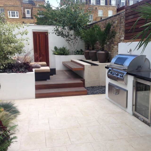 Contemporary Chelsea town garden with stainless steel BBQ unit, fridge and storage cupboard a zone for relaxing and entertaining, specialist company London.