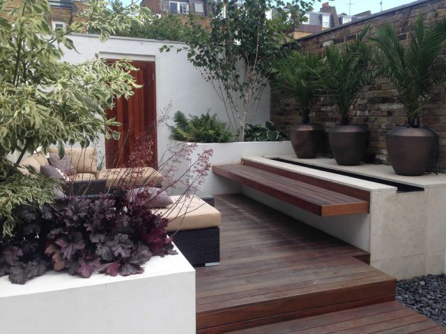 Contemporary Chelsea town garden with stainless steel BBQ unit, fridge and storage cupboard a zone for relaxing and entertaining, specialist company London.