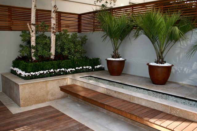 Contemporary outdoor garden space designed by Kate Gould and built by the Garden Builders, water feature, floating bench, cedar bench, landscaping contractors.