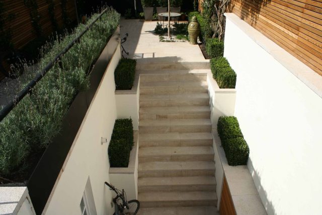 Garden Designer Chelsea Chic Modern Refinement Charm Landscape Contractor with steps sleek lines and flooring was laid with white limestone by Declan Buckley.