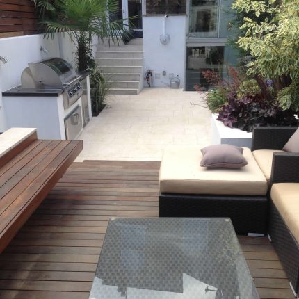 Contemporary Chelsea town garden with stainless steel BBQ unit, fridge and storage cupboard a zone for relaxing and entertaining, specialist company London.
