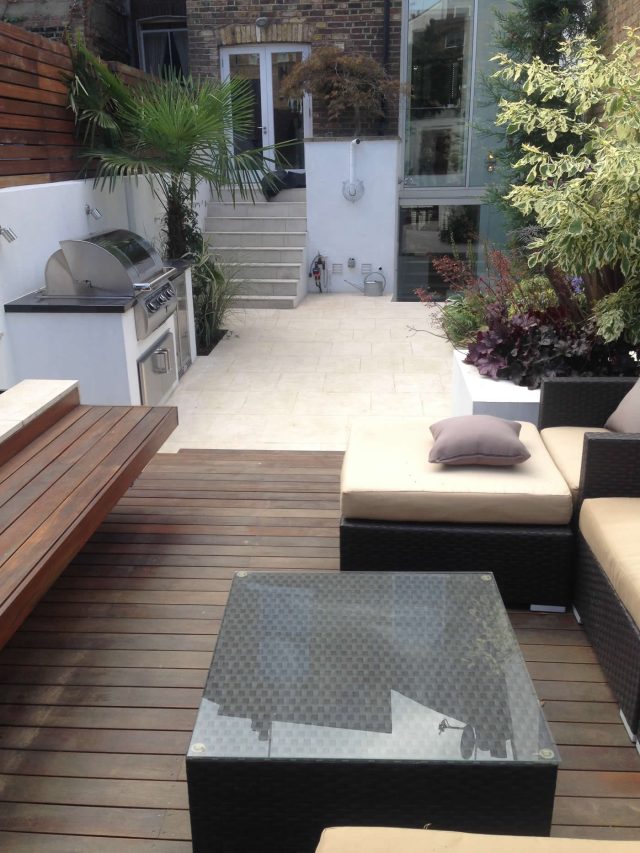Contemporary Chelsea town garden with stainless steel BBQ unit, fridge and storage cupboard a zone for relaxing and entertaining, specialist company London.