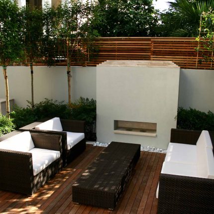 Contemporary outdoor garden space designed by Kate Gould and built by the Garden Builders, water feature, floating bench, cedar bench, landscaping contractors.