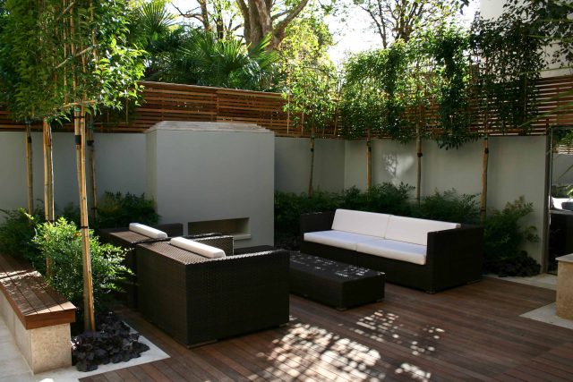 Contemporary outdoor garden space designed by Kate Gould and built by the Garden Builders, water feature, floating bench, cedar bench, landscaping contractors.