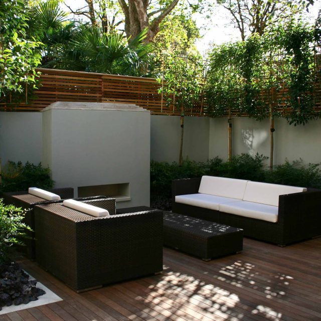 Contemporary outdoor garden space designed by Kate Gould and built by the Garden Builders, water feature, floating bench, cedar bench, landscaping contractors.
